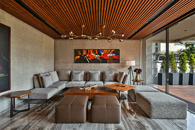 wooden pvc ceiling design with a chandelier in a luxury living r